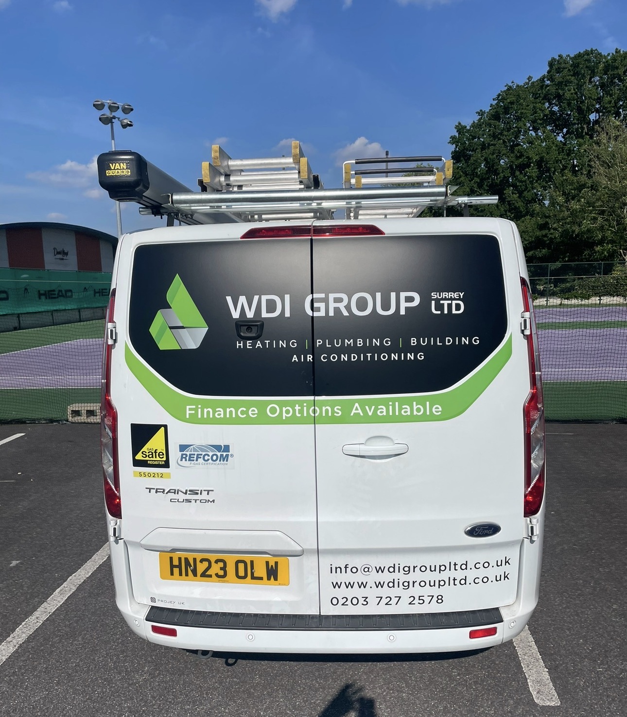Rear of a WDI Group (Surrey) Ltd van showing REFCOM F-Gas and Gas Safe registration marks